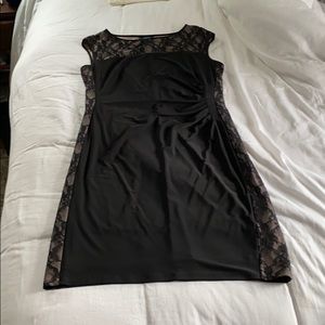 Black fitted dress with lace sides and top.